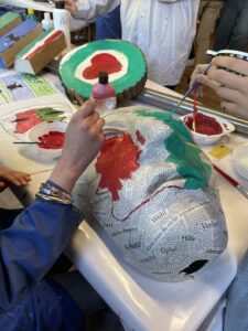 eine Maske wird rot-weiß-grün bemalt